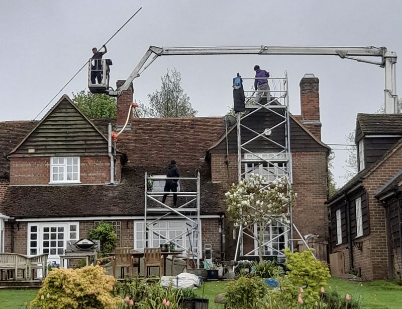 The Moss Cleaners using cherry picker and scaffolding to clean roof safely and professionally in 21 Roehampton High St, London SW15 4HL, UK, 21 Roehampton High St, London SW15 4HL, UK